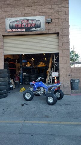 Blue ATV Parked Outside Tire Shop 003 — VDK Tire Shop