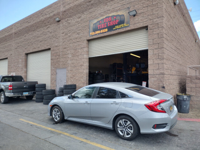 Silver Car Parked Outside Tire Shop 038 — VDK Tire Shop
