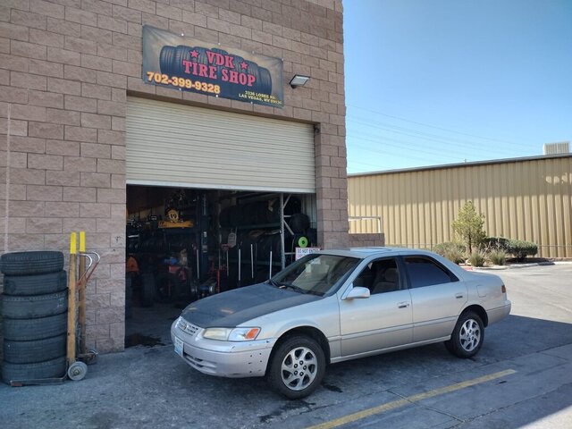 Silver Sedan Parked At Tire Shop 045 — VDK Tire Shop