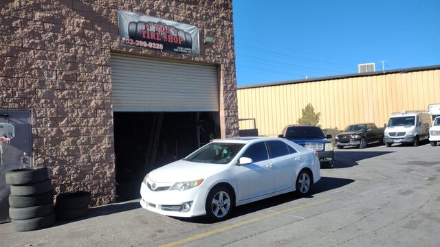 White Car Parked Outside Tire Shop 010 — VDK Tire Shop