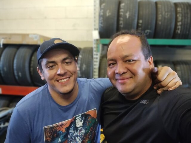 VDK Tire Shop team smiling inside the tire shop