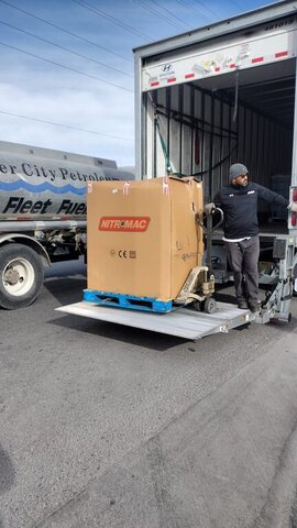 Worker Unloading Pallet From Truck 007 — VDK Tire Shop