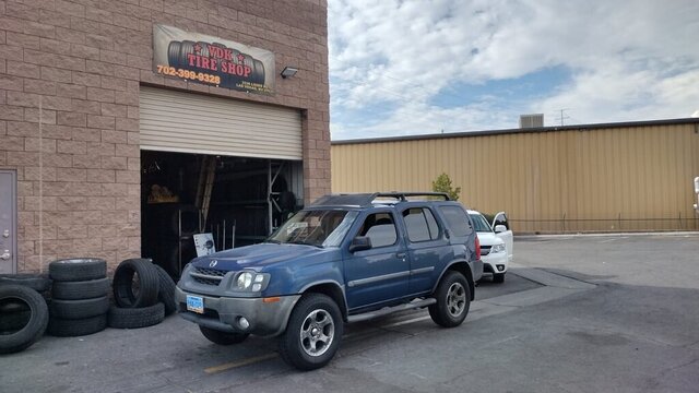 Blue SUV Parked Outside Tire Shop 037 — VDK Tire Shop