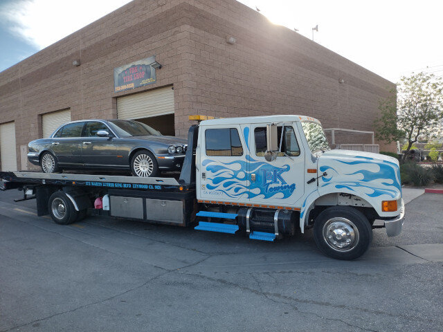 Flatbed Tow Truck Transporting Jaguar 026 — VDK Tire Shop